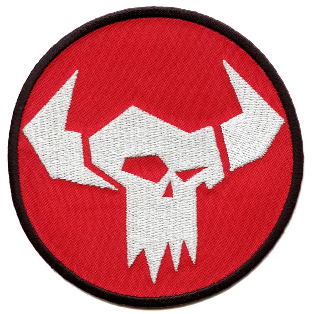 Embroidered patch of a Warhammer 40k orc banner symbol on a red background