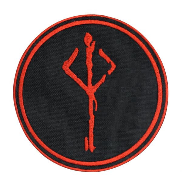 A round black patch with a red embroidered symbol resembling the Bloodborne Hunter's Mark. The symbol is centered within the patch, and the design is encircled by two thin red rings.