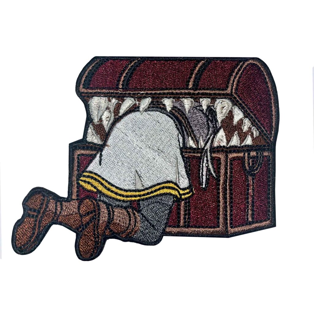 Frieren Mimic patch featuring Frieren caught in a mimic chest, crafted with detailed anime embroidery inspired by Sousou no Frieren.